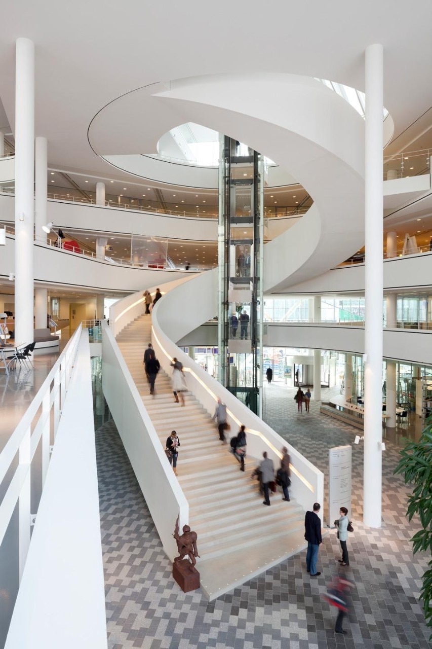 The building departs from a central and bright atrium from where a sculptural staircase soars up and connects its many facilities