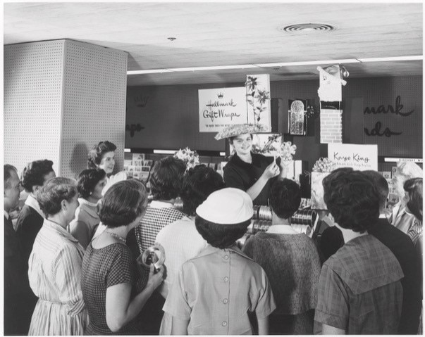 Gift stylist demonstrating how to gift wrap, 1950-1960. Courtesy Hallmark Corporate