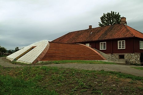 L’ala ovest, semicilindrica, è sezionata ai due estremi da una copertura vetrata. 
Una rampa centrale costituisce il percorso attraverso le rovine storiche, mentre una rampa laterale porta al secondo piano dell’edificio preesistente, che ospita gli uffici amministrativi
