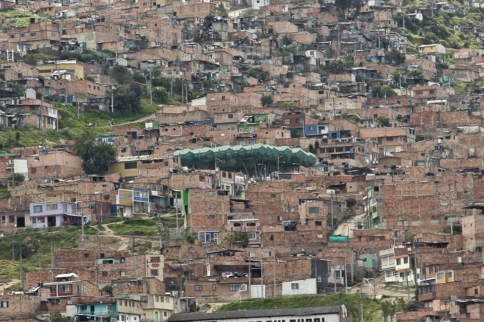 La copertura ideata da Giancarlo Mazzanti emerge tra i tetti della favela. Le favelas di Bogotá occupano il 55% del tessuto urbano. Gli insediamenti informali sono sistemi attivi, dinamici e produttivi, sempre in crescita, riescono facilmente ad adattarsi ad una società in continuo mutamento.