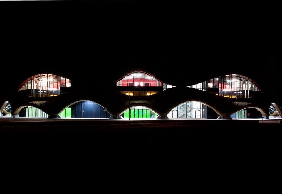 Gli occhi notturni che si aprono lungo la copertura ondulata dell'arena