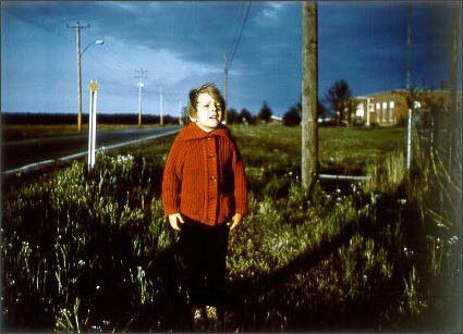William Eggleston, Untitled (Boy in a Red Cardigan), 1971. Pinakothek der Moderne, Munich. © 2003 The Eggleston Artistic Trust
