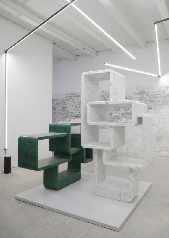 The two bookshelves in Carrara and Guatemala green marble by arik Levy welcome the visitors in the environments of SPUMA – Space for the Arts. Photo: Federico Floriani.