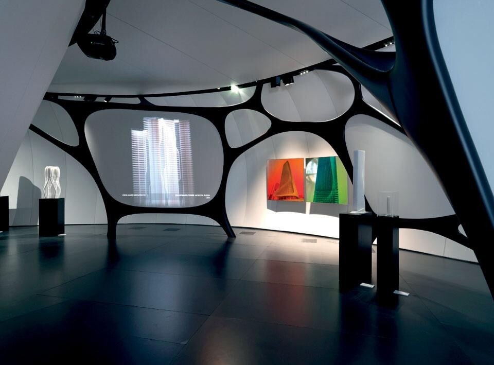 In alto: Le forme e le strutture organiche creano una varietà costante degli spazi espositivi generando un contesto unico in cui l’arte diventa un’esperienza a trecentosessanta gradi. Fotografia: Francois Lacour; qui sopra: Zumtobel ha firmato l’illuminazione della mostra: delicata luce LED, angoli di emissione precisi e sobrio design dei faretti conferiscono all’ambiente grande fascino.  