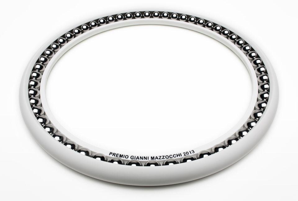Premio Gianni Mazzocchi 2013, caratterizzato da un guscio toroidale di Corian by DuPont fresato a controllo numerico che lascia intravedere solo in parte 56 sfere. Photo Carlo Lavatori