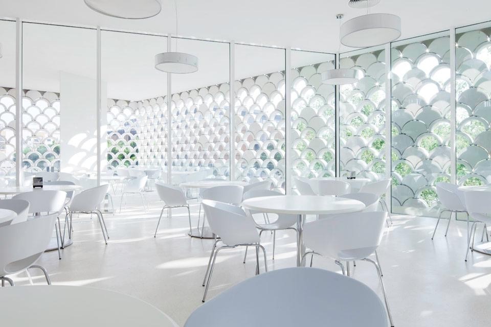 The cafe/restaurant. Here the building exterior, from compact, thins out filtering natural light and enhancing the fusion between interior space and the surrounding context. Photo © <a href="www.brunecky.com" target="_blanK">Radek Brunecky</a> The cafe/restaurant. Here the building exterior, from compact, thins out filtering natural light and enhancing the fusion between interior space and the surrounding context. Photo © <a href="www.brunecky.com" target="_blanK">Radek Brunecky</a>