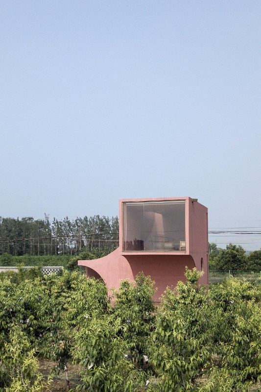 A pinkish concrete folie in the Chinese countryside