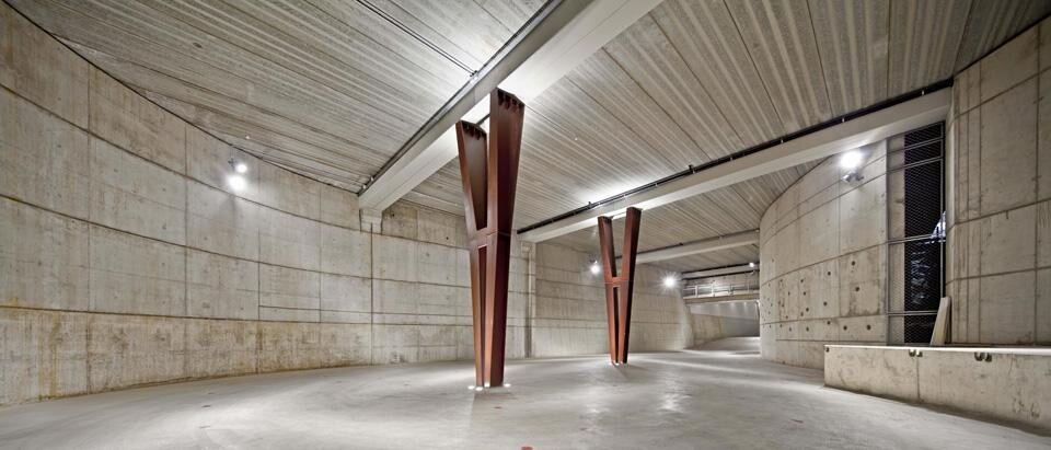 L'edificio è stato progettato con due corpi principali: il primo è uno spazio tradizionale destinato ai magazzini, al parcheggio, allo showroom, all'auditorium; il tutto collocato in un piano sotterraneo oscuro, circondato da strutture di calcestruzzo L'edificio è stato progettato con due corpi principali: il primo è uno spazio tradizionale destinato ai magazzini, al parcheggio, allo showroom, all'auditorium; il tutto collocato in un piano sotterraneo oscuro, circondato da strutture di calcestruzzo